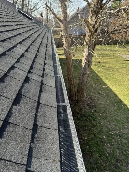 A photo of a customer's home with new roofing and gutters installed.