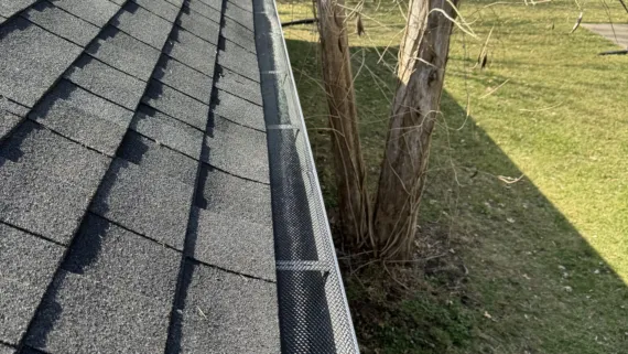 A photo of a customer's home with new roofing and gutters installed.